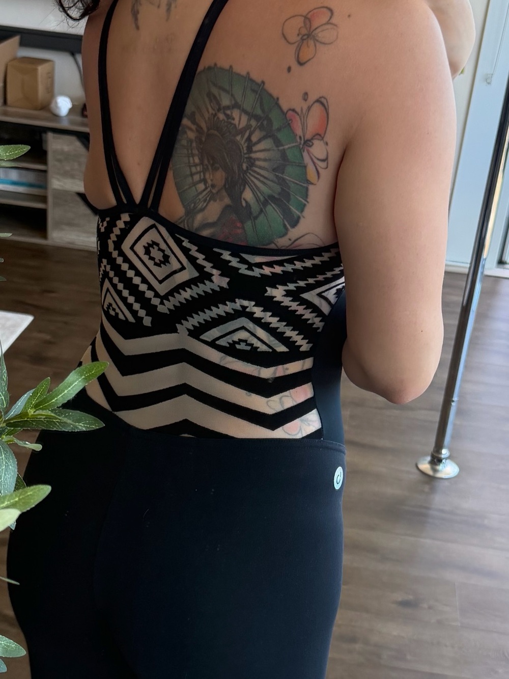 Fitted black jumpsuit with built in bra , and mesh back